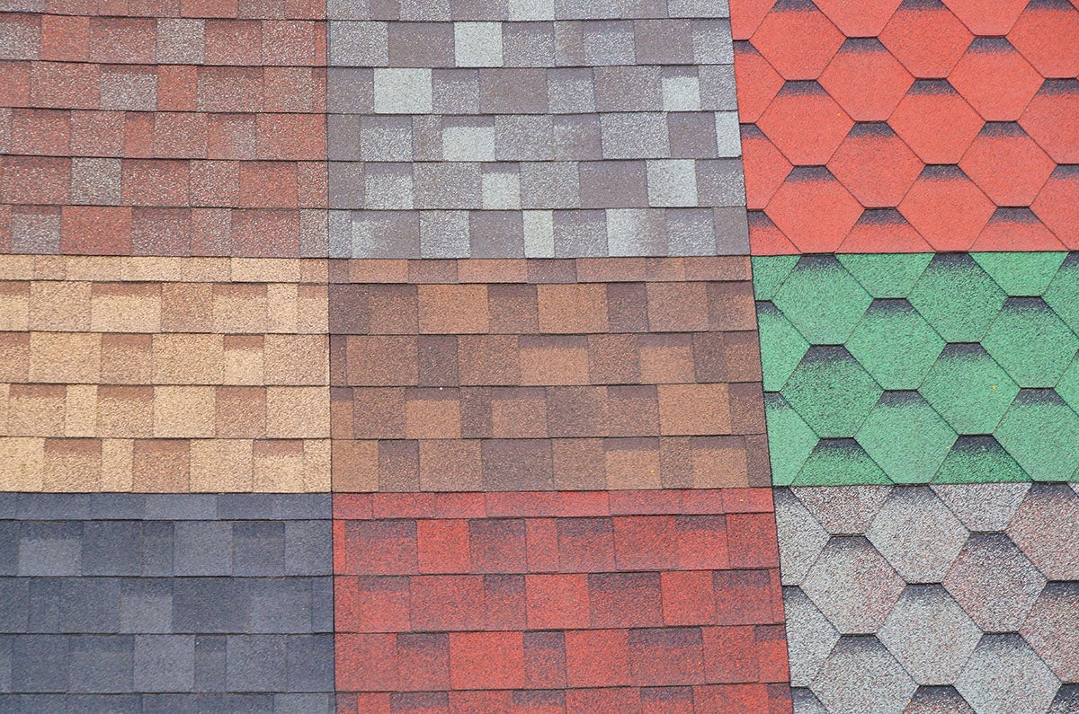 A collage of multiple types and colors of roof shingles forming a grid pattern.